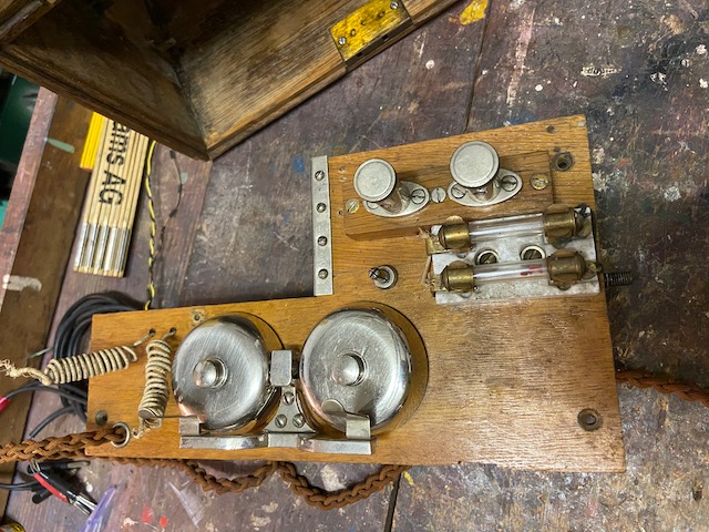 Main board top, battery leads, bells, line connectors, lightning arrestors, pin to store crank handle
